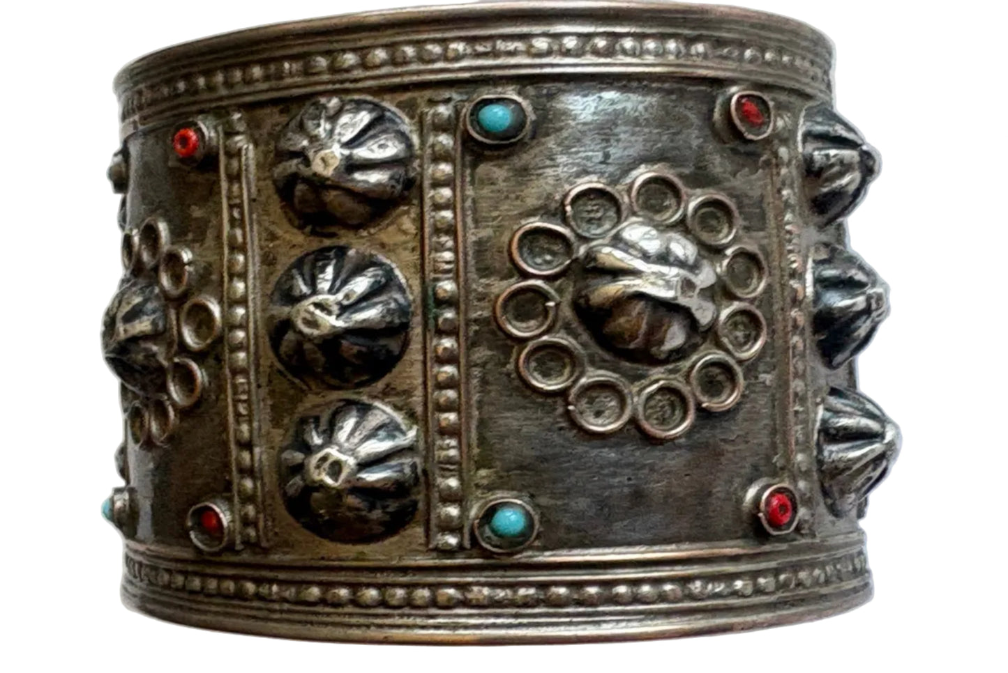 Decorative silver bracelet with intricate designs on a white background