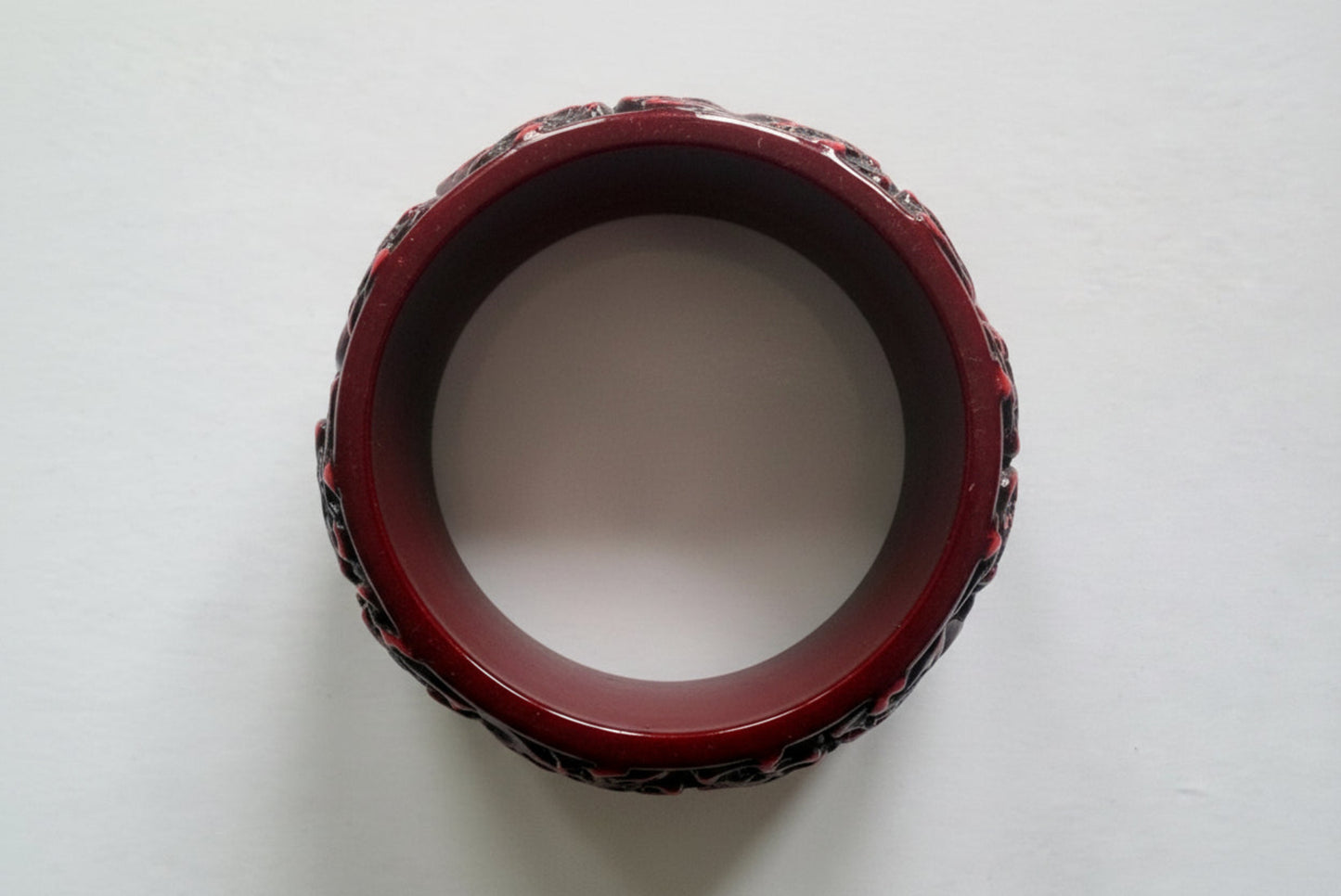 Red resin bangle on a white background