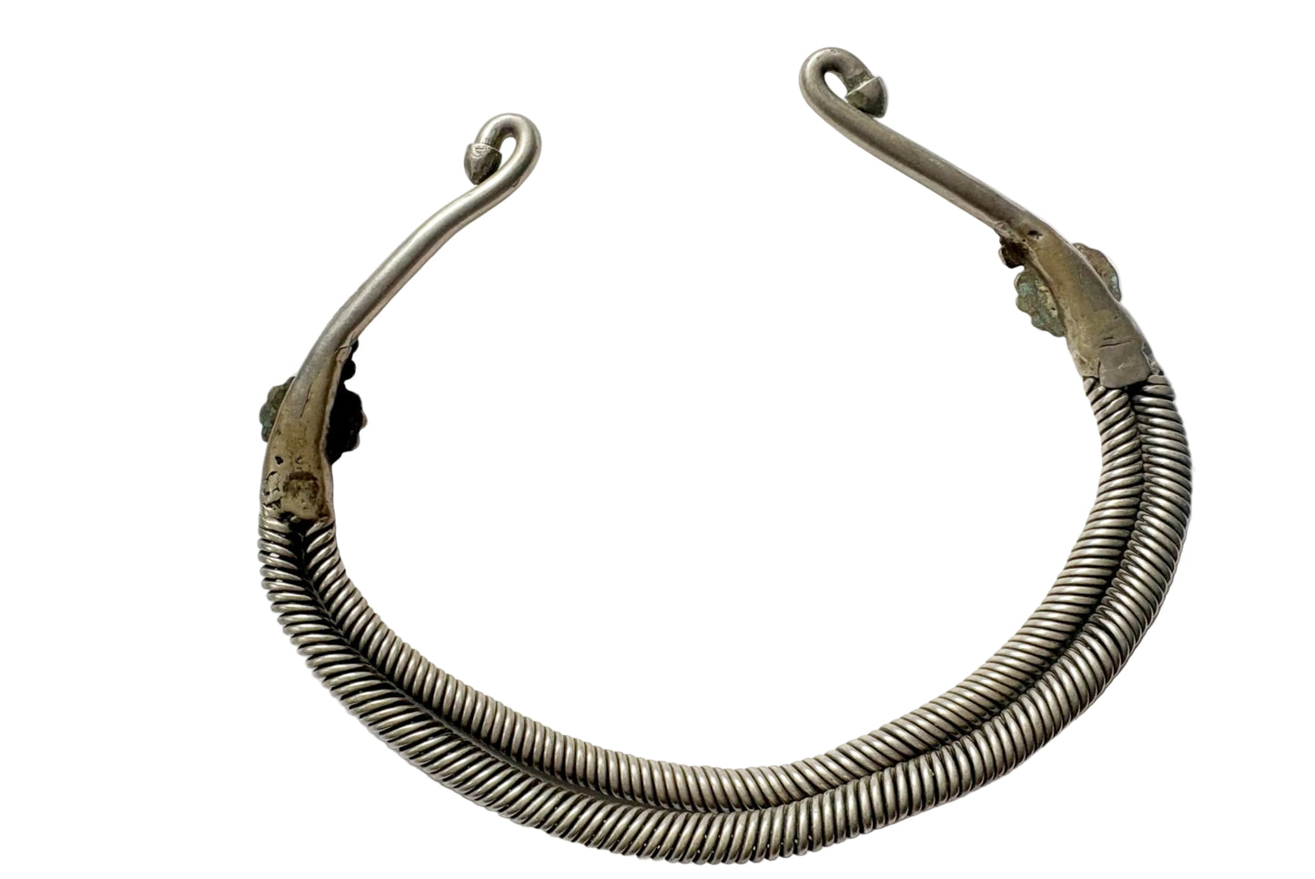 the back of a metal collar with a coiled, ribbed lower band and two hooked upper clasps, displayed on a plain white background.