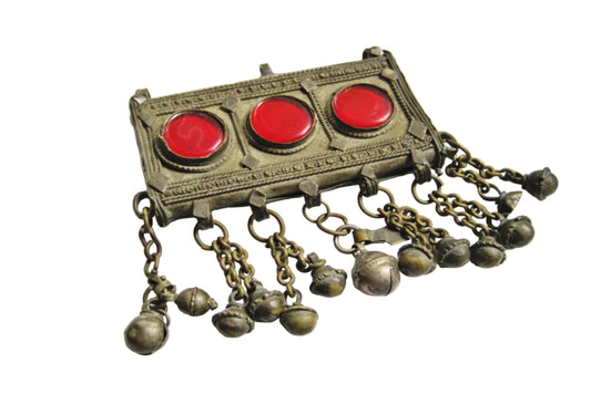 Bedouin pendant with red stones and dangling chains on a white background