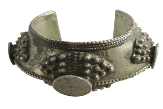 Silver bracelet with intricate designs on a white background