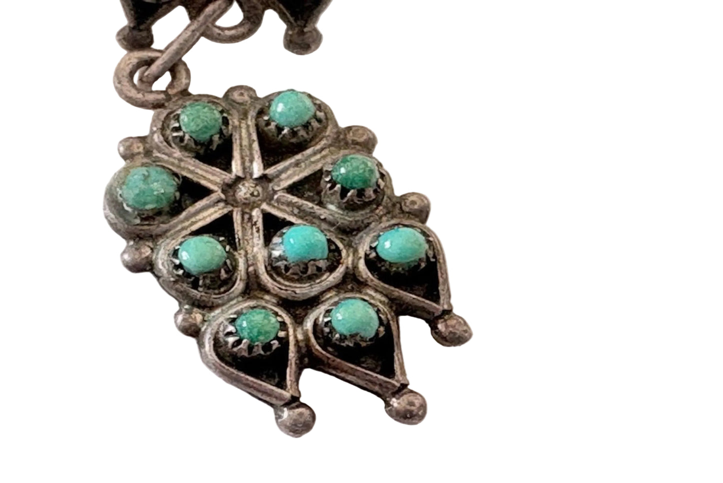 Zuni earrings with turquoise stones on a white background