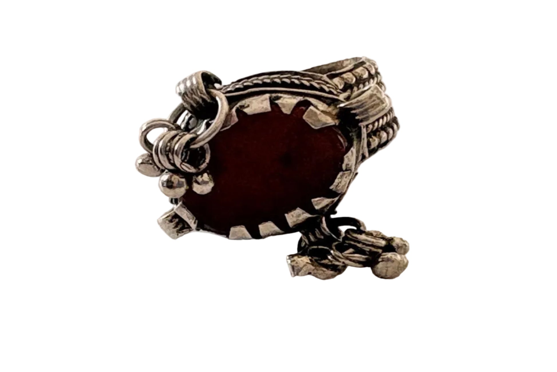 Silver ring with a red stone on a light gray background