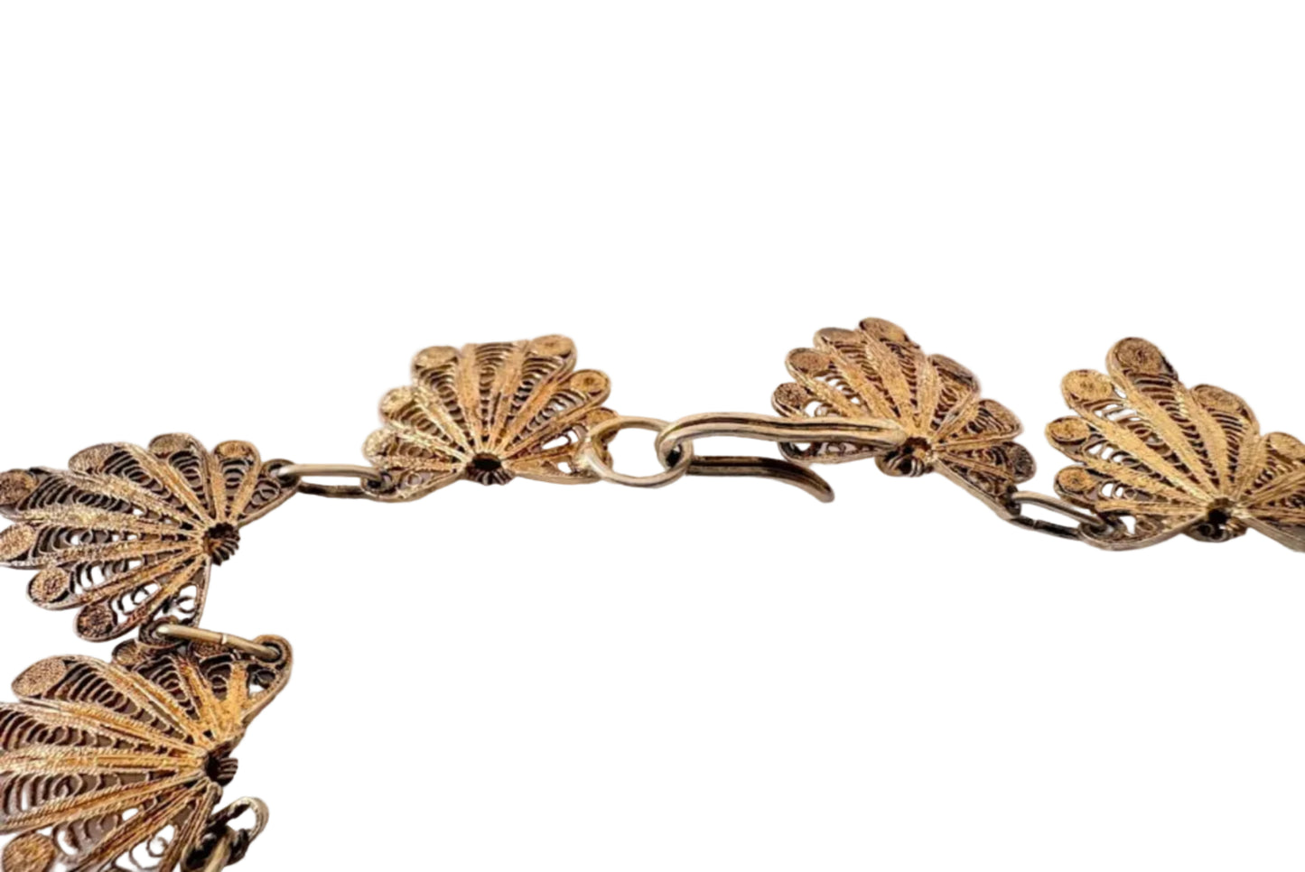 Detail of the back and clasp of gold plated silver filigree floral necklace on a light background