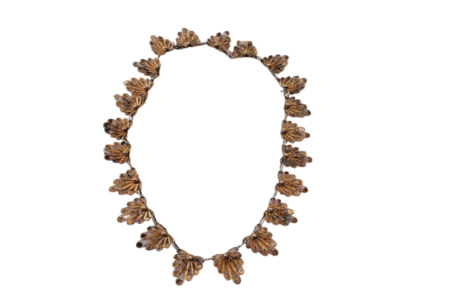 Decorative gold colored filigree choker necklace on a white background