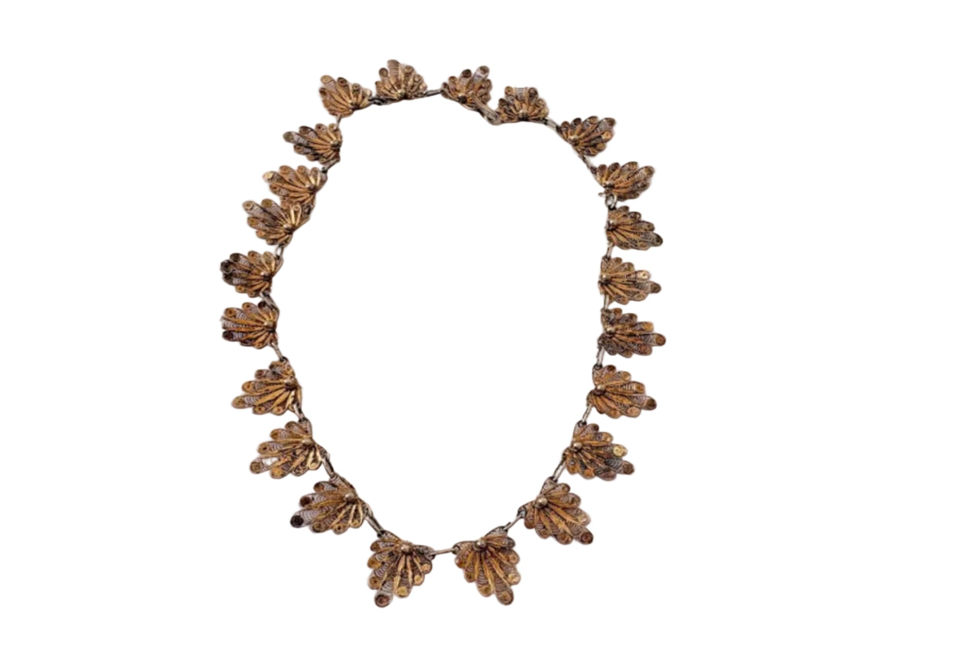 Decorative gold colored filigree choker necklace on a white background