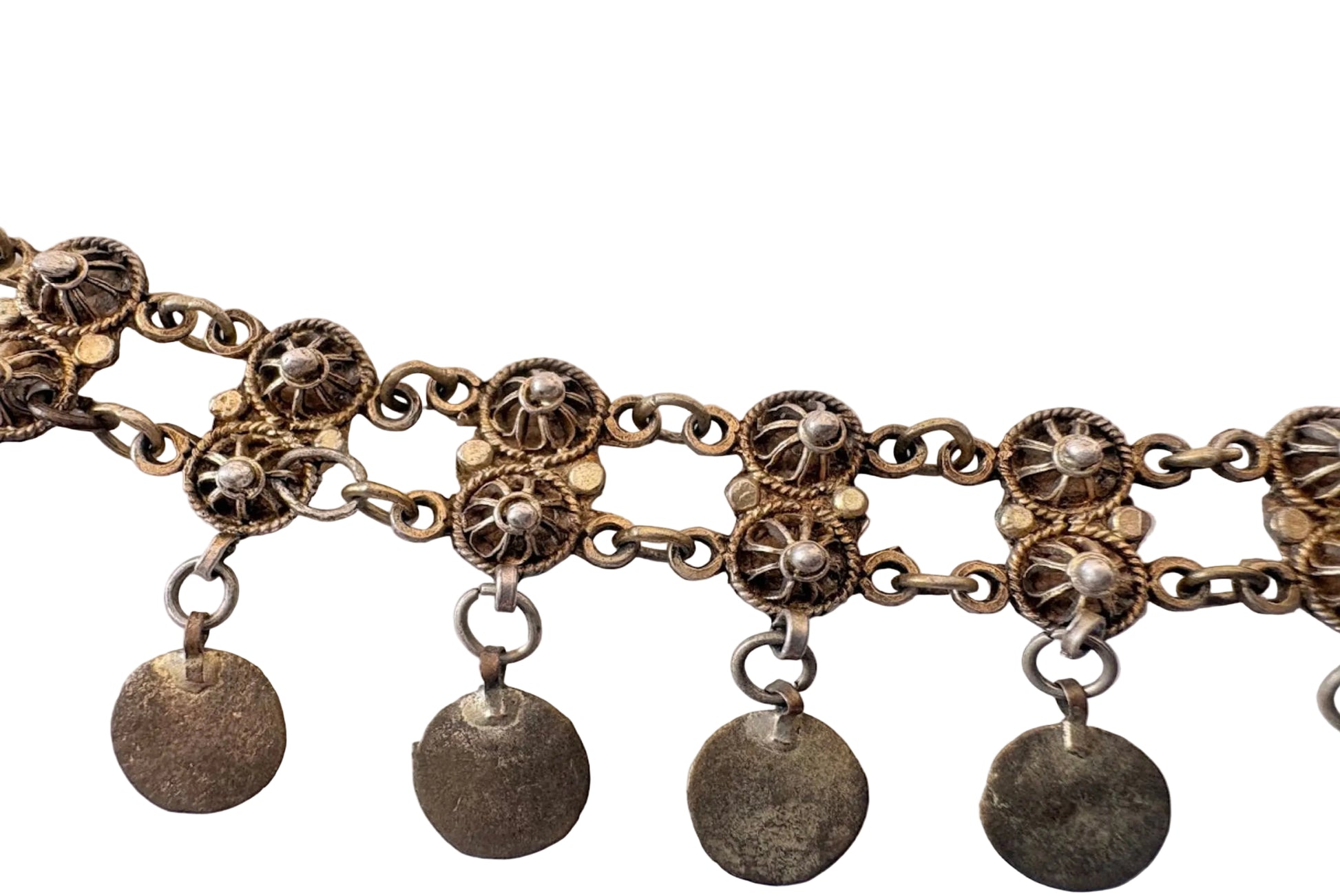 Close up of filigree Greek headband on a white background