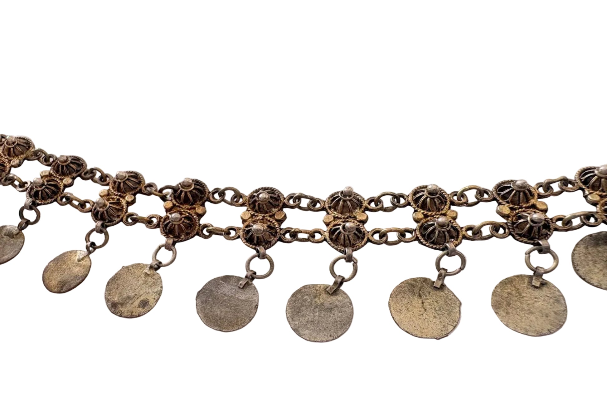 Silver chain necklace with circular pendants on a light background