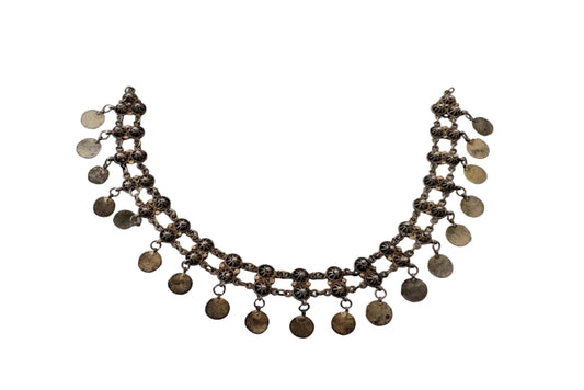 Necklace with coin pendants on a light gray background