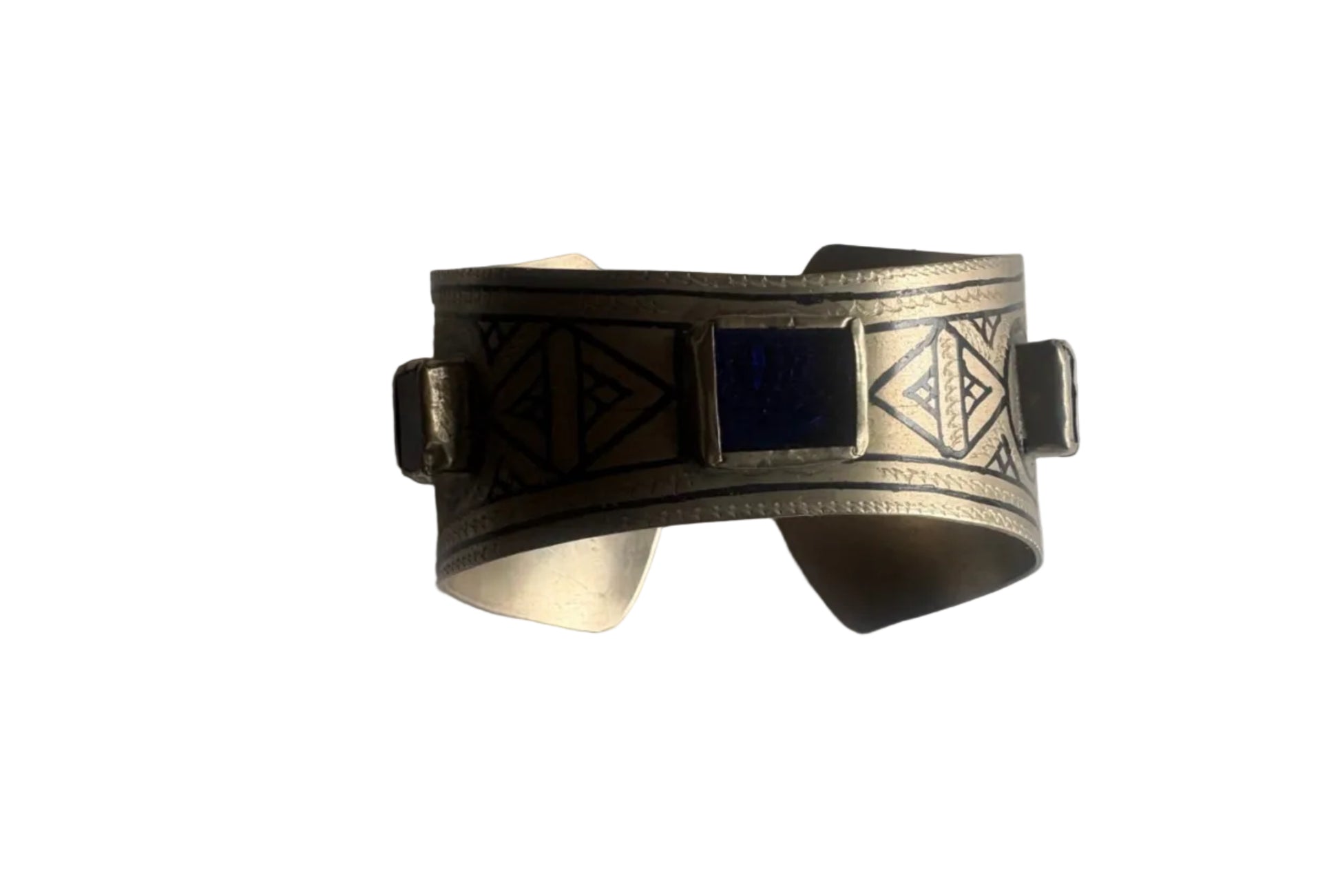 Silver cuff bracelet with geometric design on a white background
