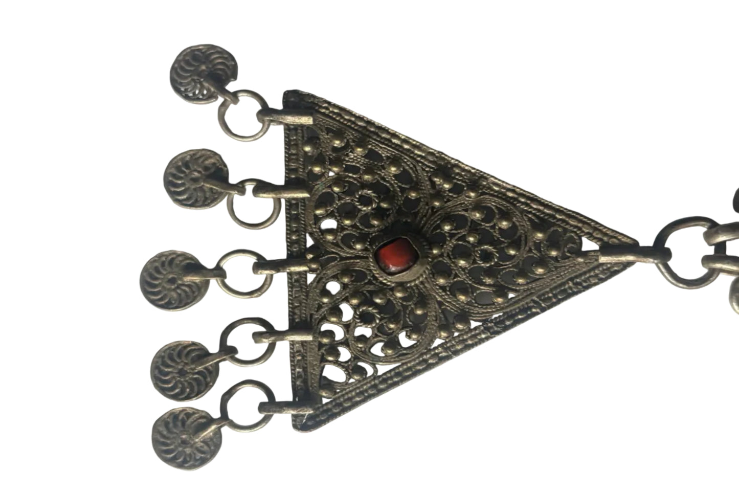 Decorative silver pendant with intricate designs on a white background