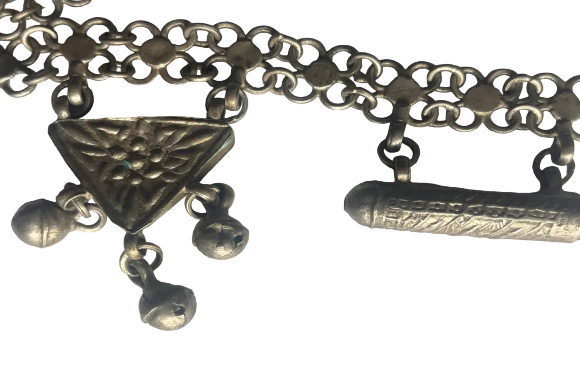 Close-up of a silver necklace with intricate designs on a white background