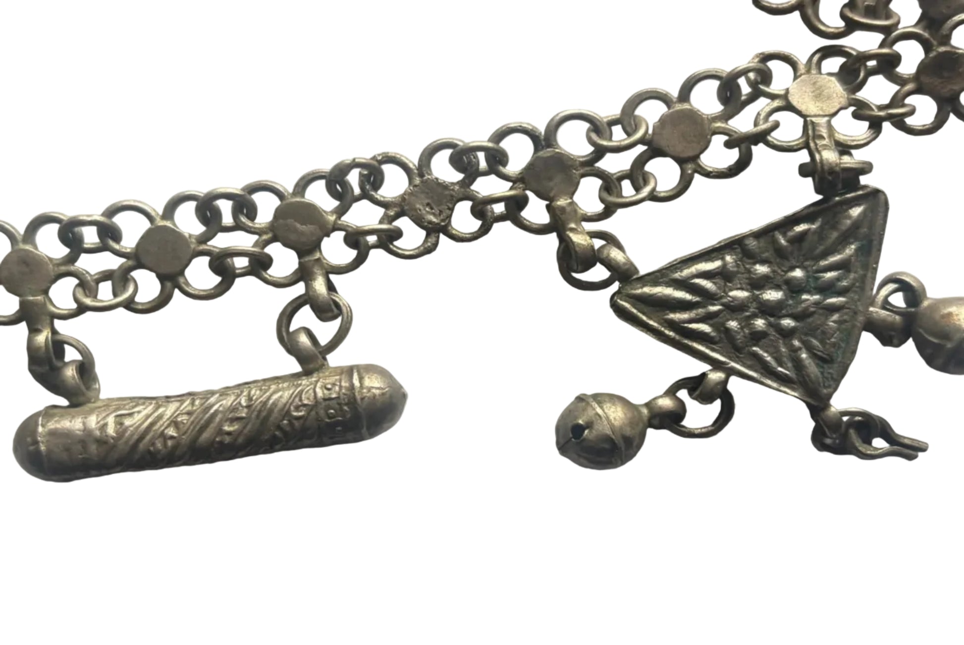 Close-up of a silver necklace with geometric pendants on a white background