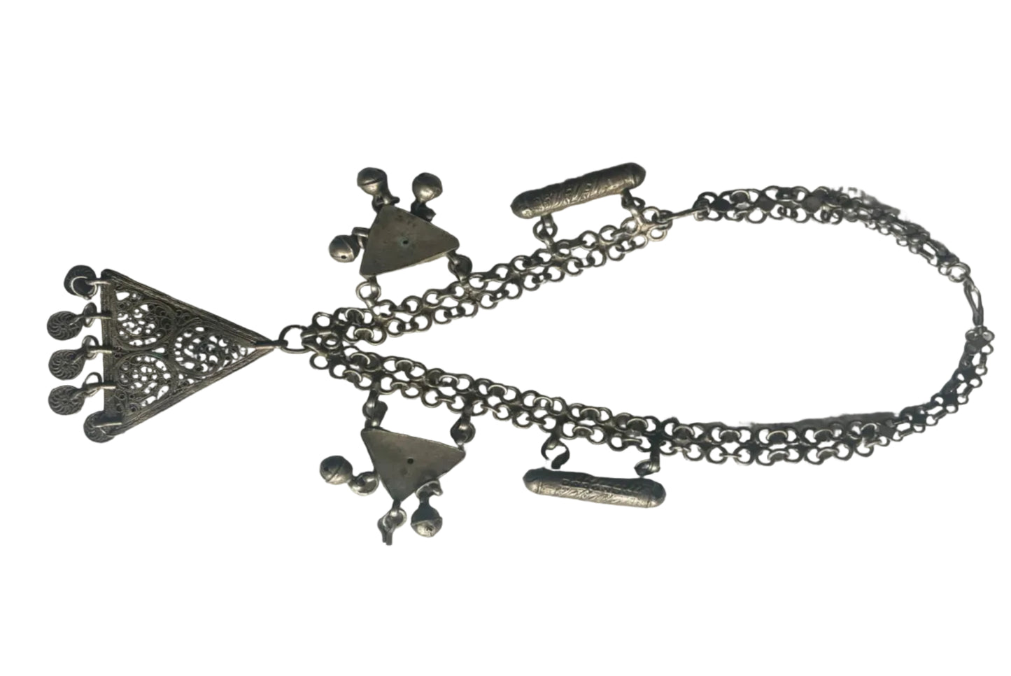 Silver necklace with various charms on a white background