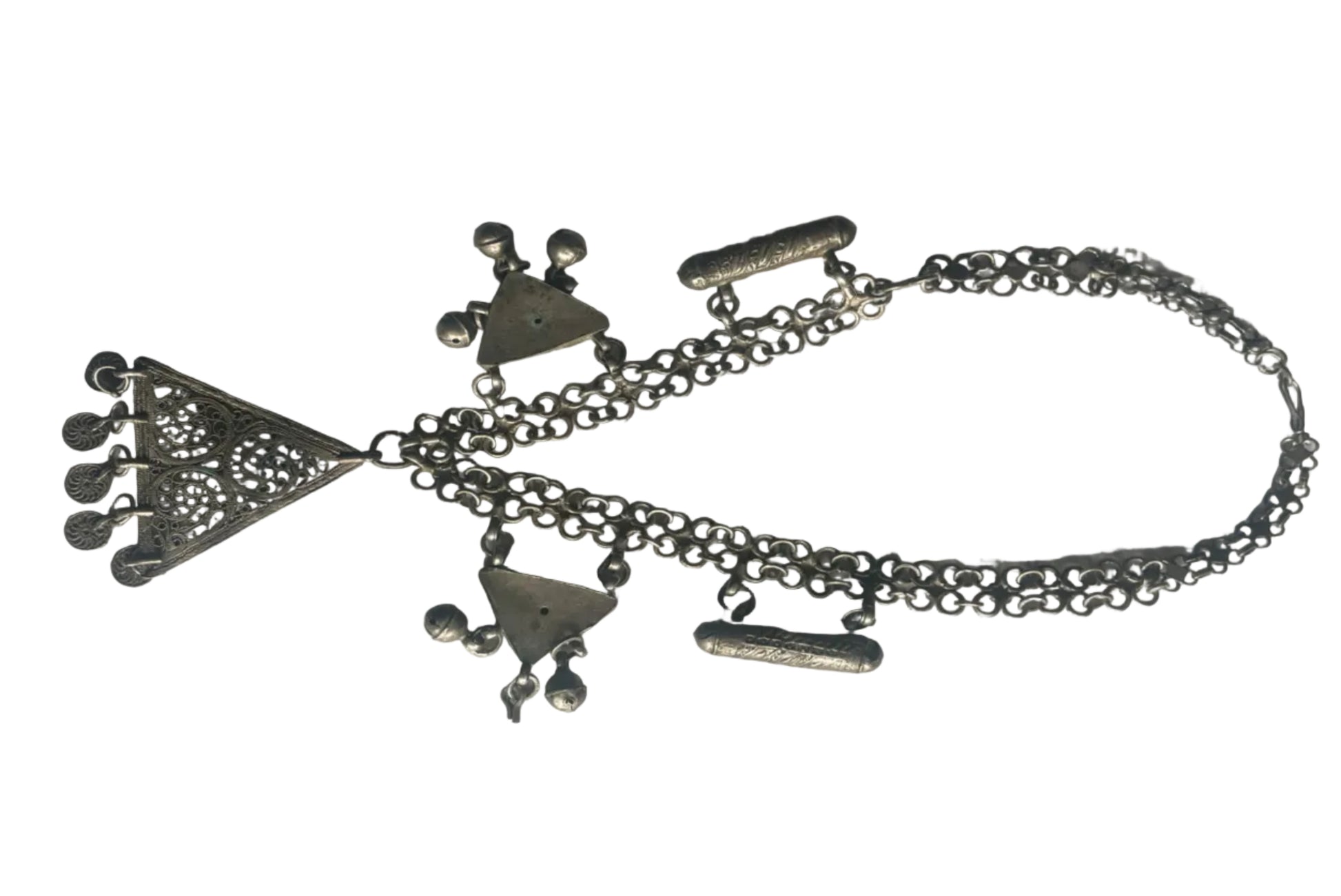 Silver necklace with various charms on a white background