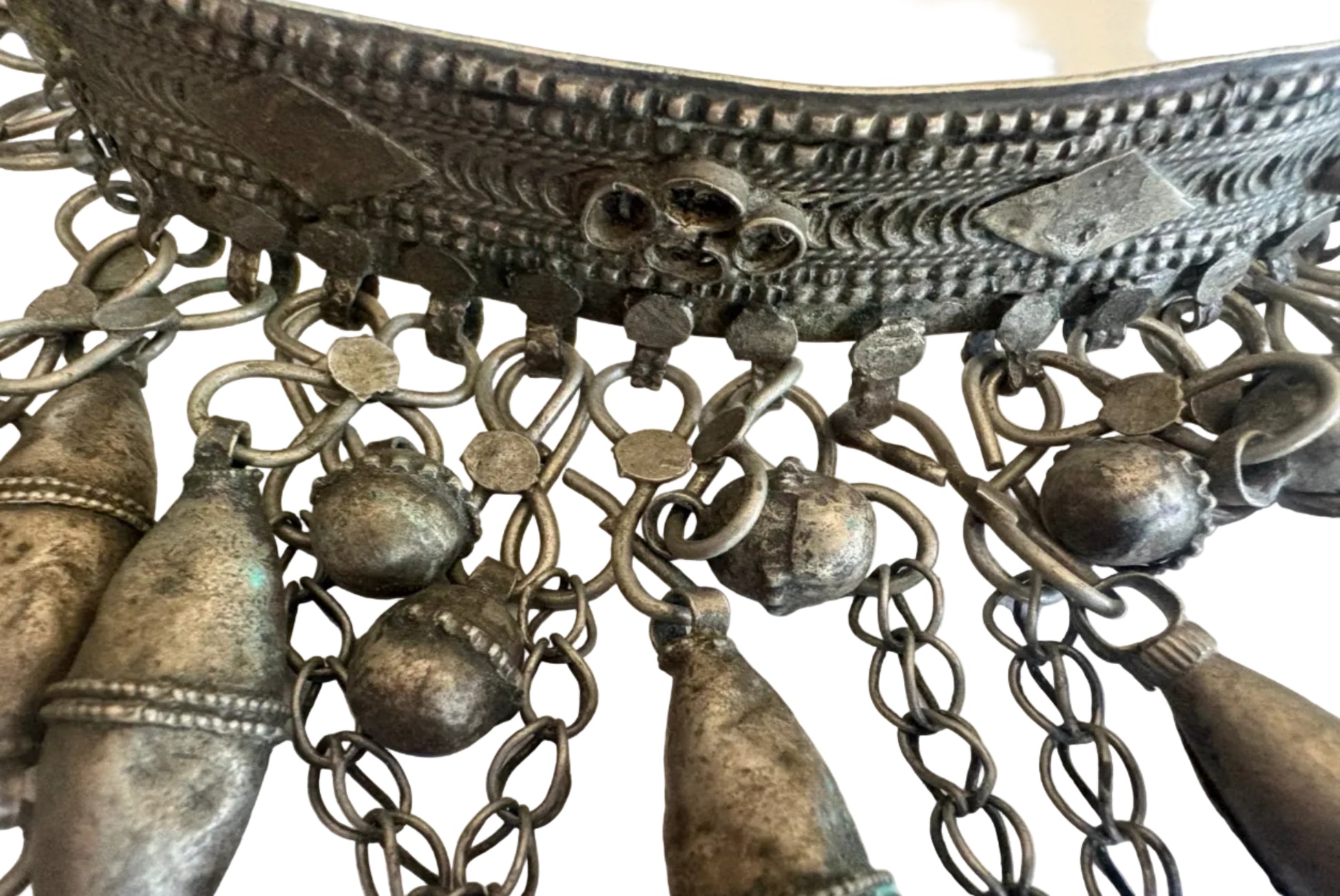 Close-up of an ornate torc necklacet with intricate designs and chains.