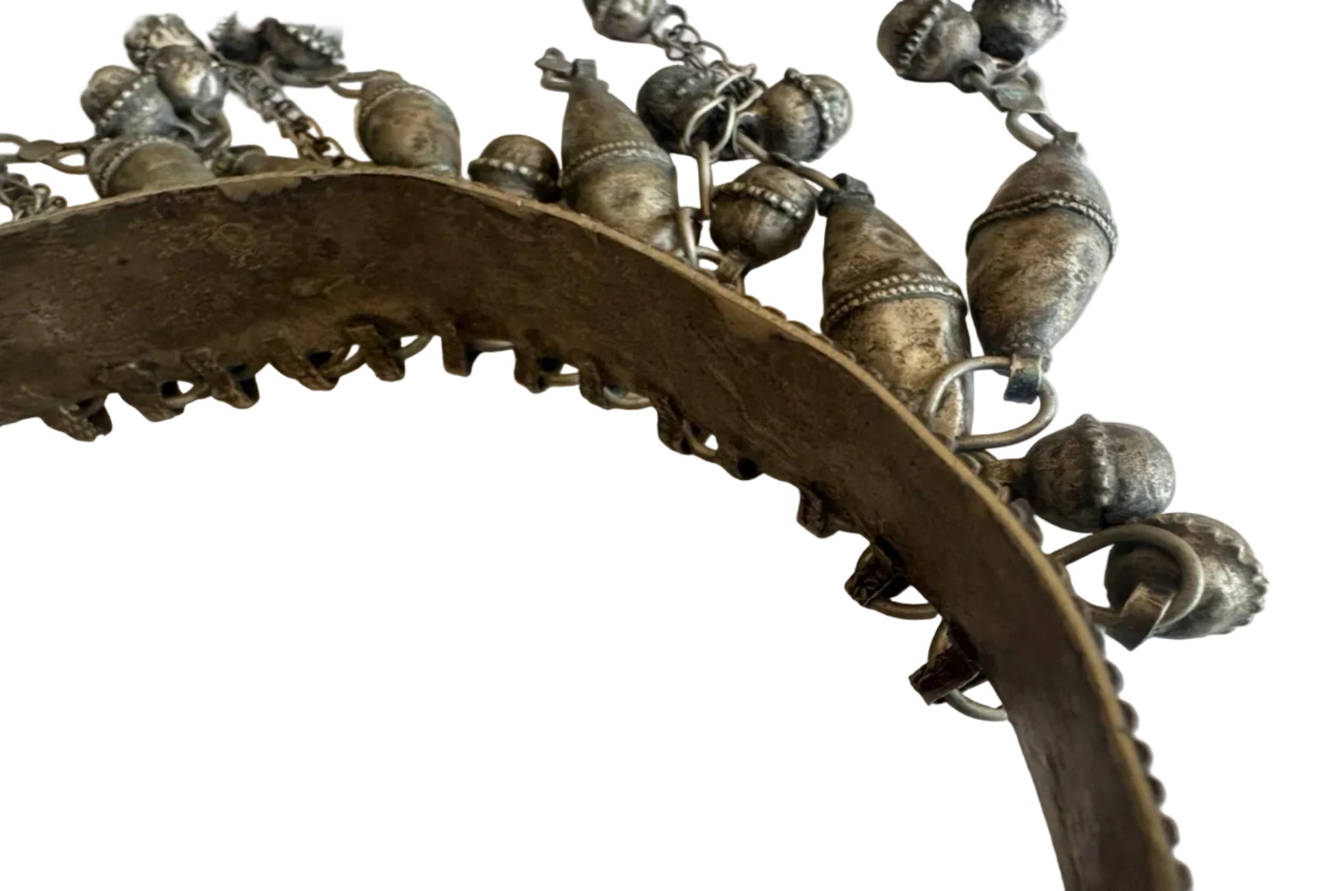 Close-up of a torc necklace with intricate designs on a white background