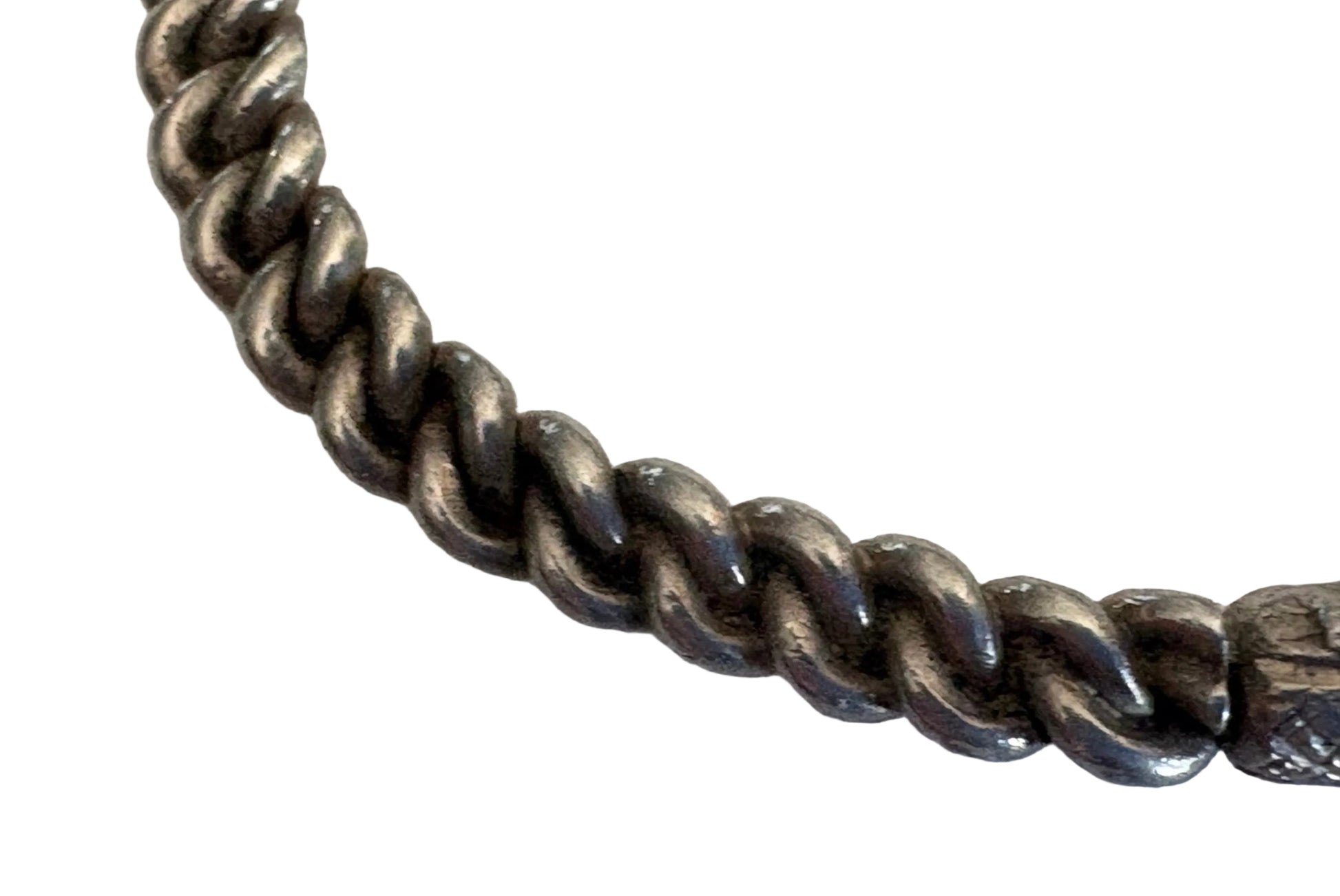 Close-up of a twisted silver chain on a white background