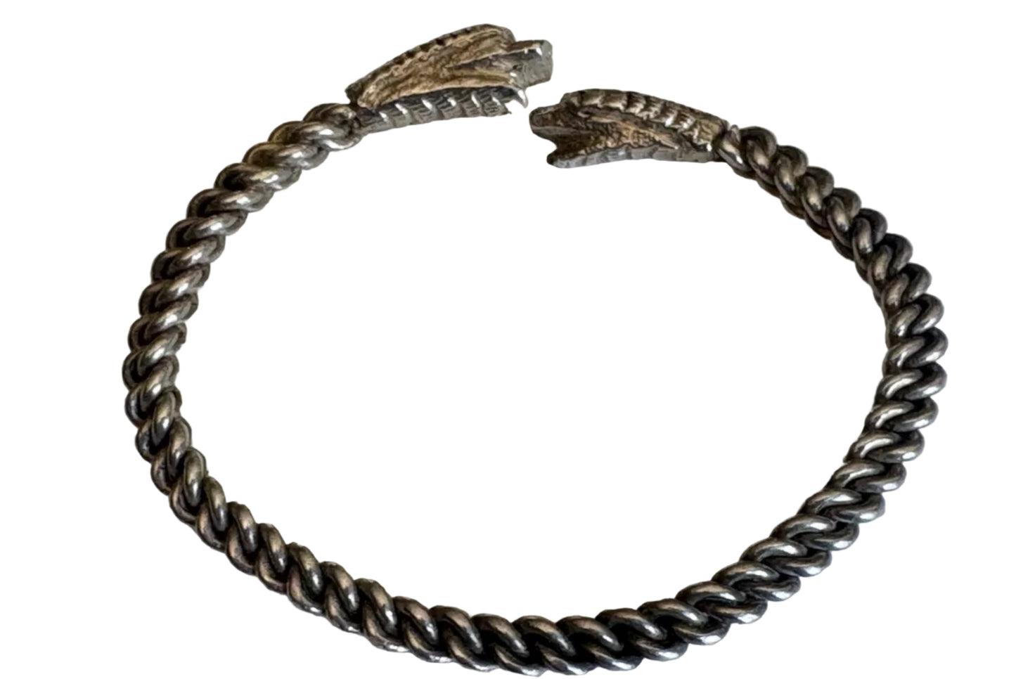 Silver bracelet with two snake heads on a white background