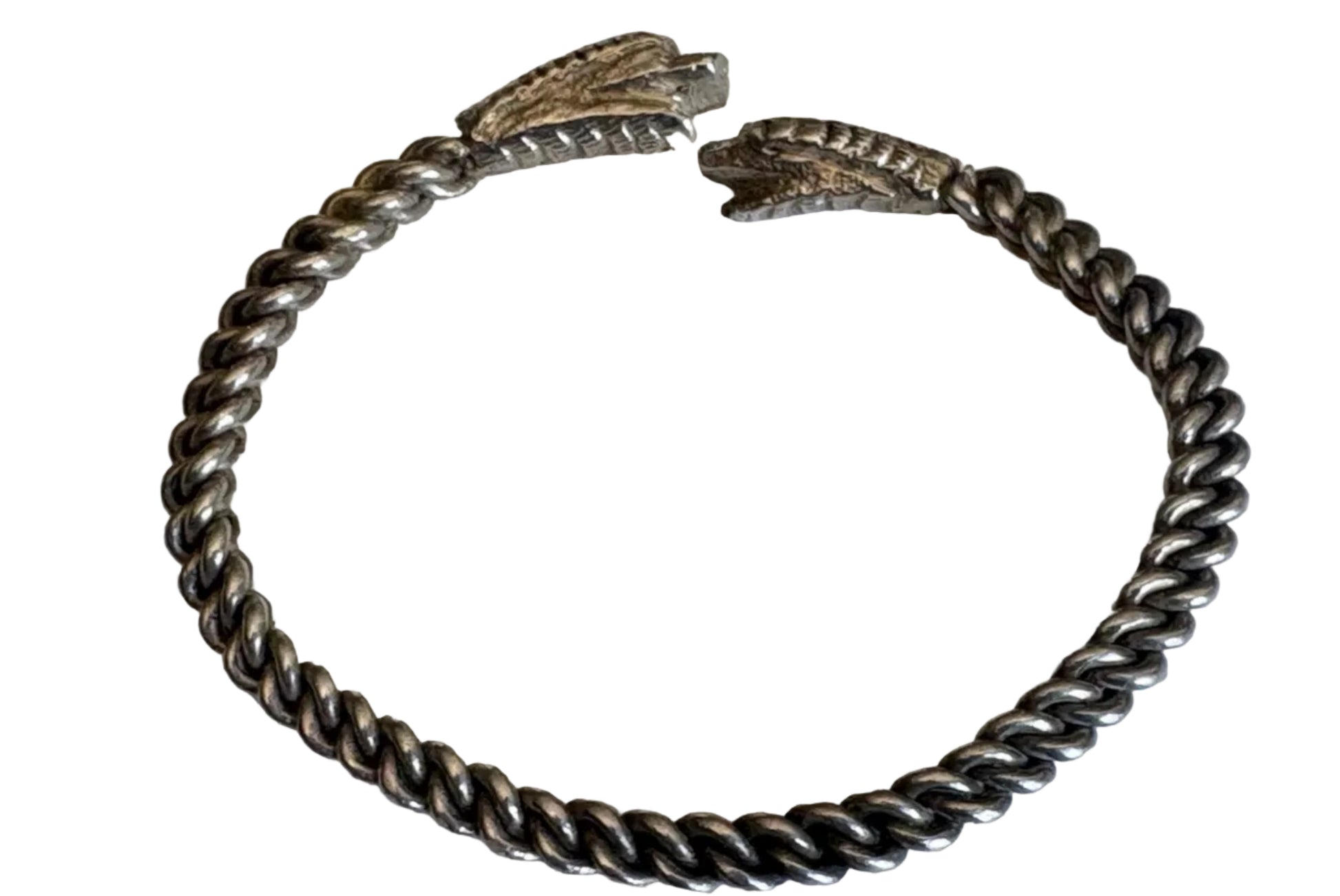 Silver bracelet with two snake heads on a white background