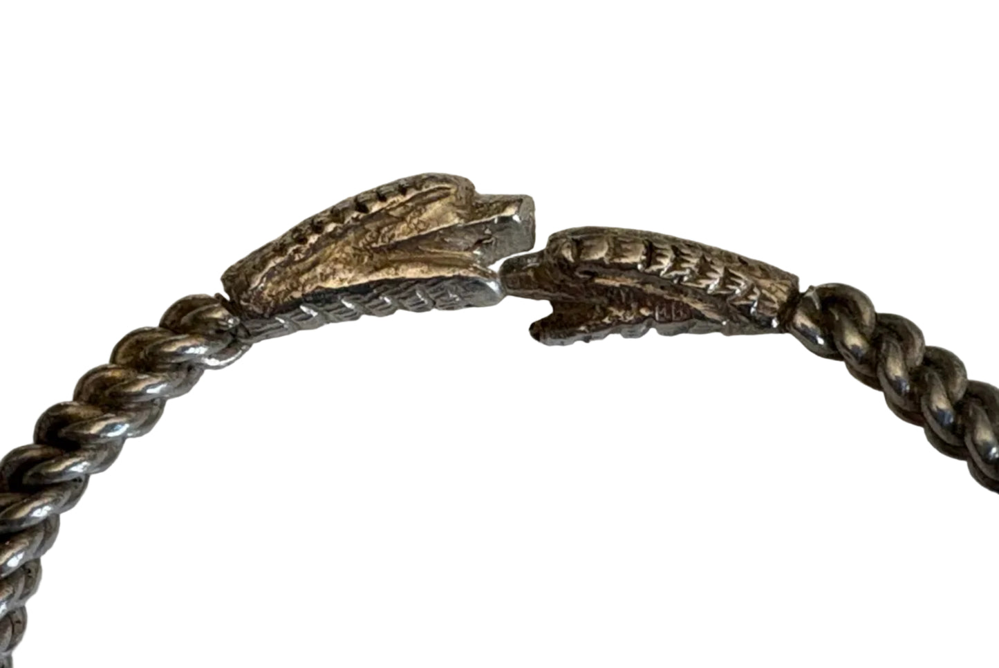 Silver bracelet with dragon or snake head clasps on a light  background