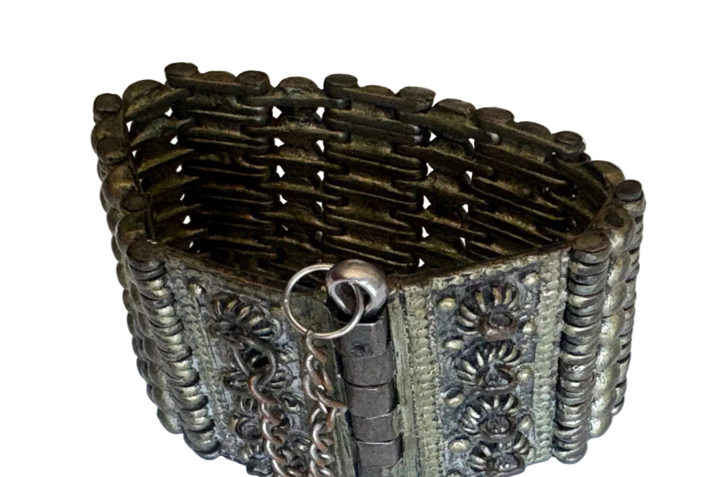 Decorative bracelet with intricate metalwork on a white background