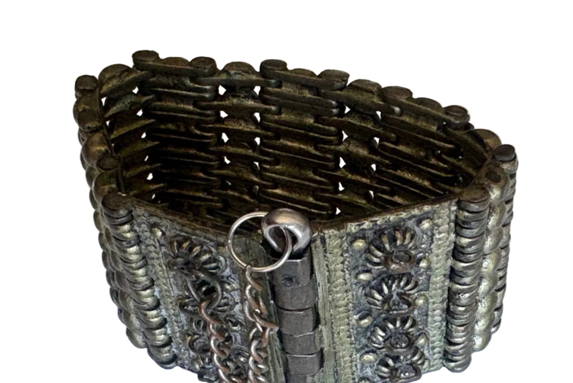 Decorative bracelet with intricate metalwork on a white background