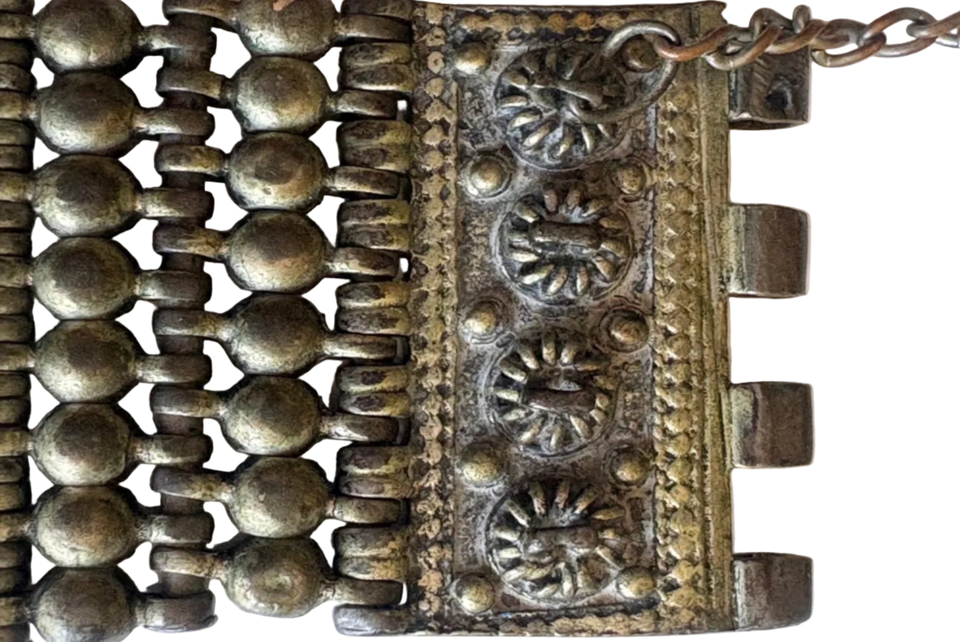 Details of a Palestinian Habbayat bracelet with intricate patterns on a white background