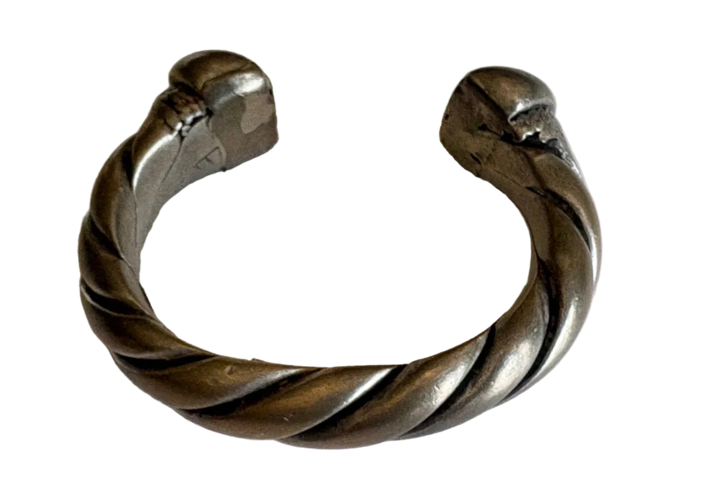 Silver bracelet with a twisted design on a white background