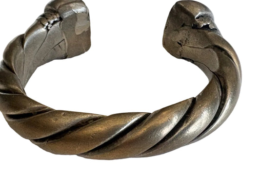 Silver twisted bracelet on a light background