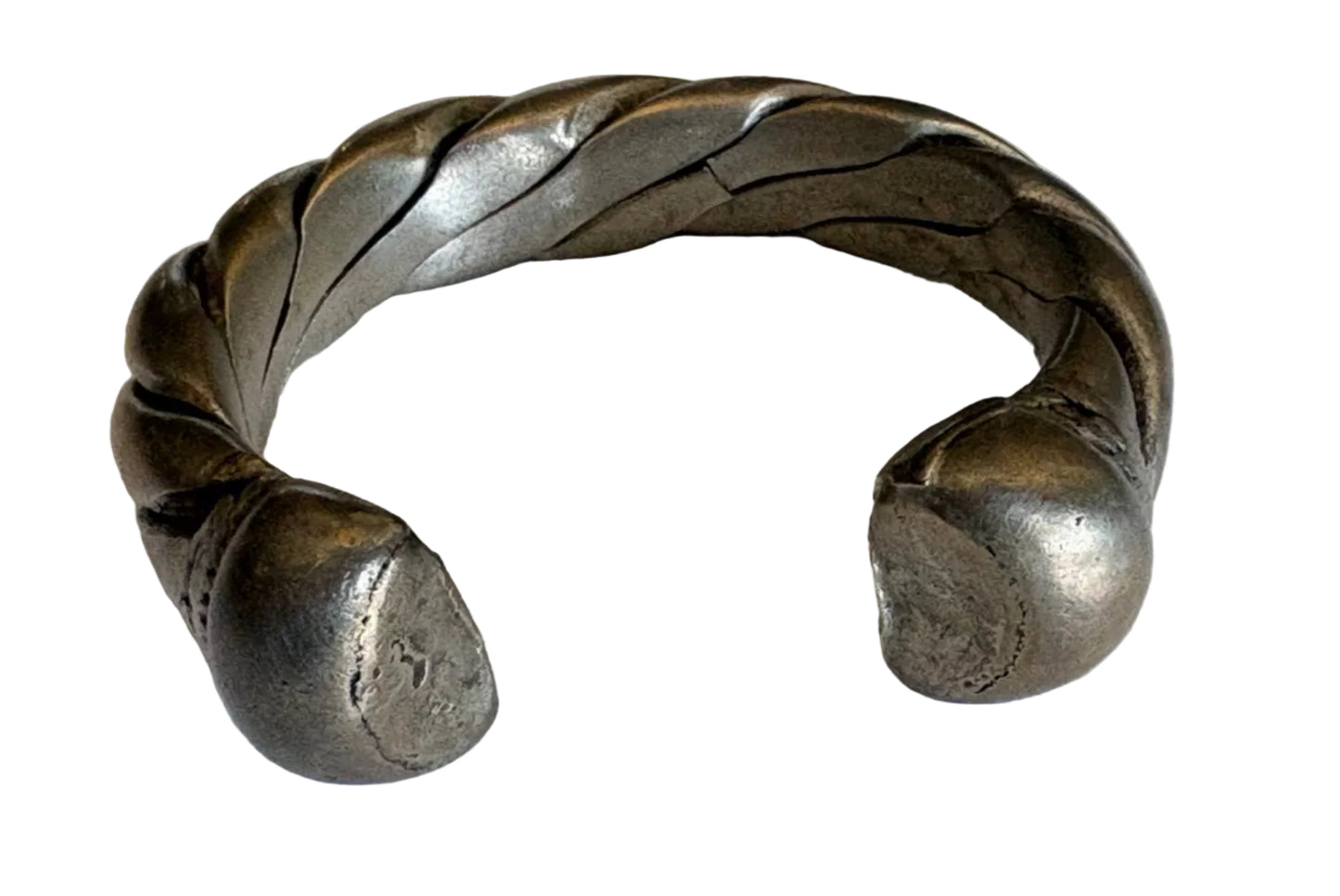Silver bracelet with braided design on a white background