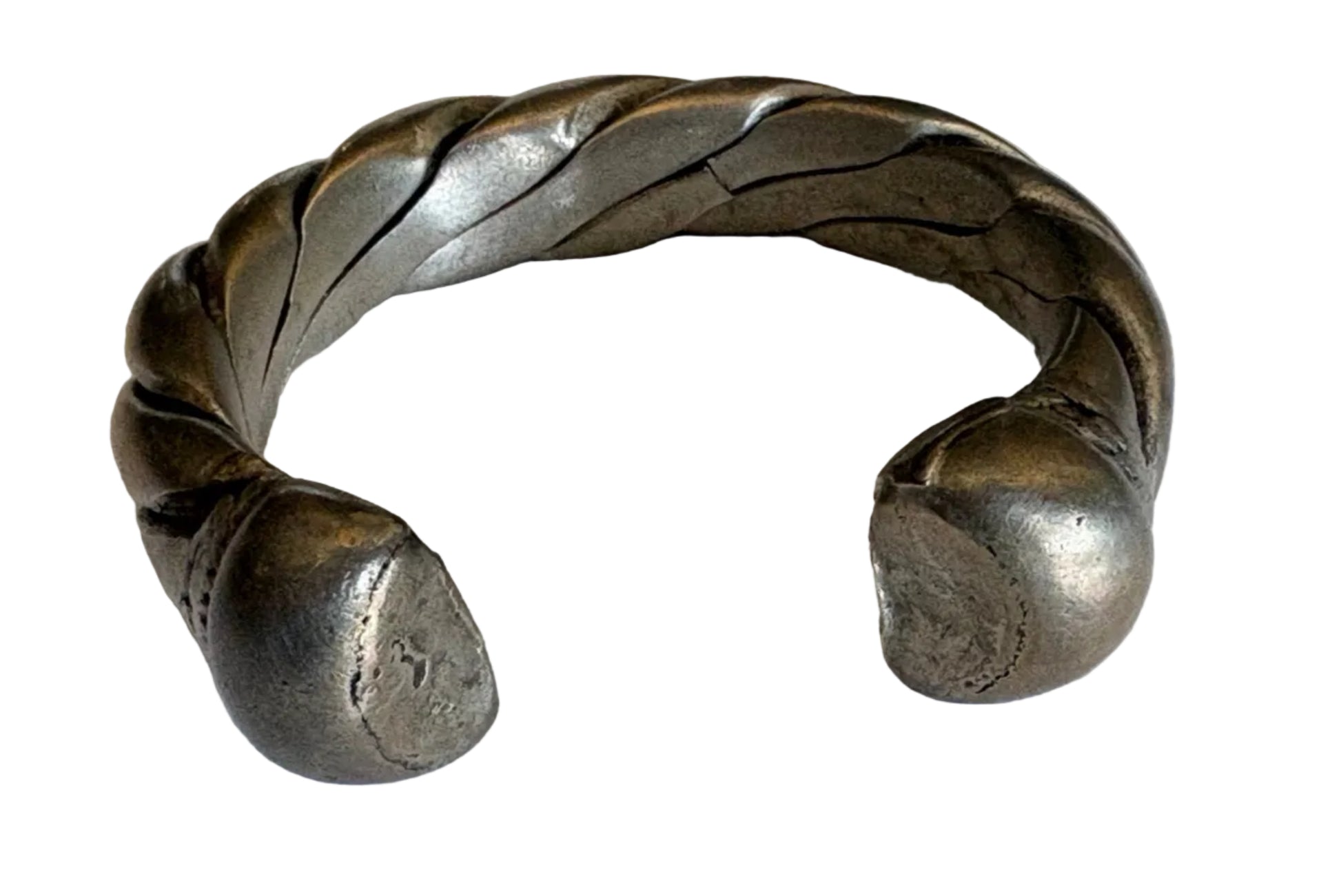 Silver bracelet with braided design on a white background