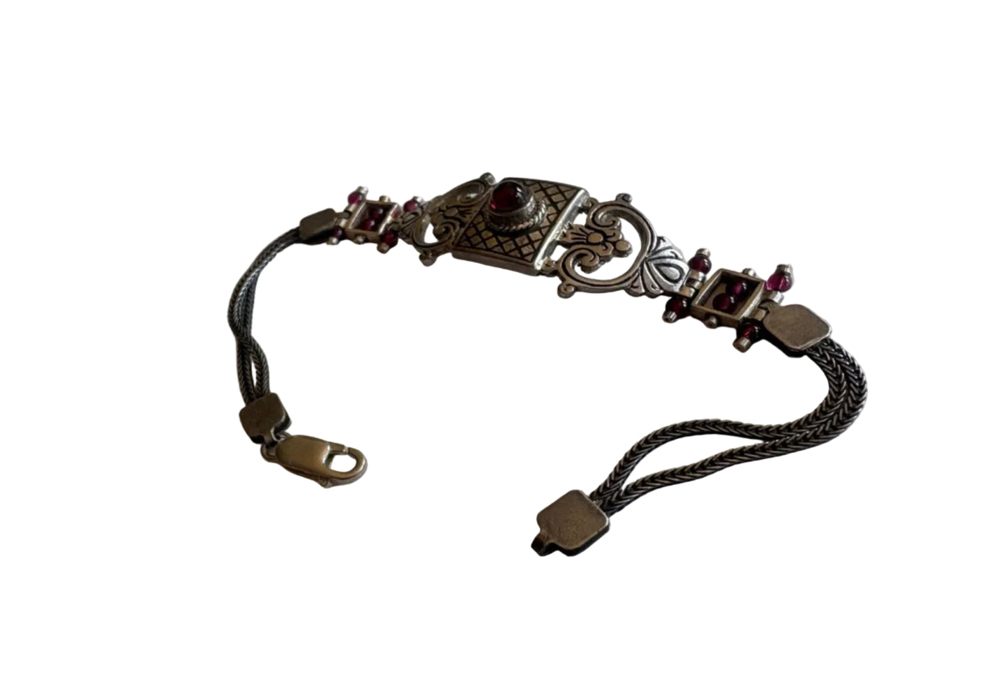 Decorative bracelet with intricate design on a white background