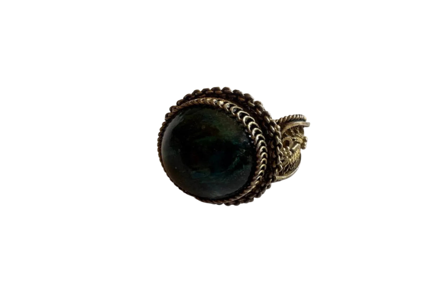 Ring with a dark stone and gold-tone setting on a light gray background