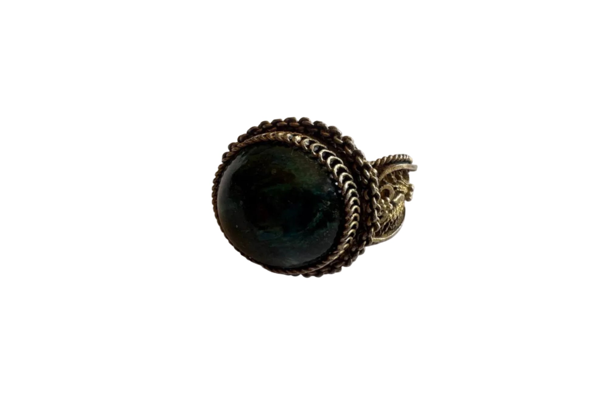 Ring with a dark stone and gold-tone setting on a light gray background