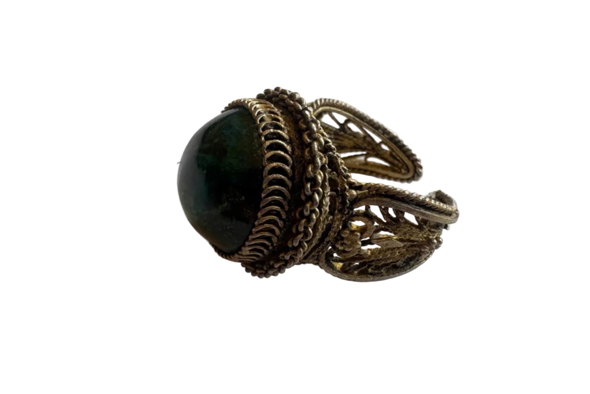 Decorative ring with a dark stone on a white surface