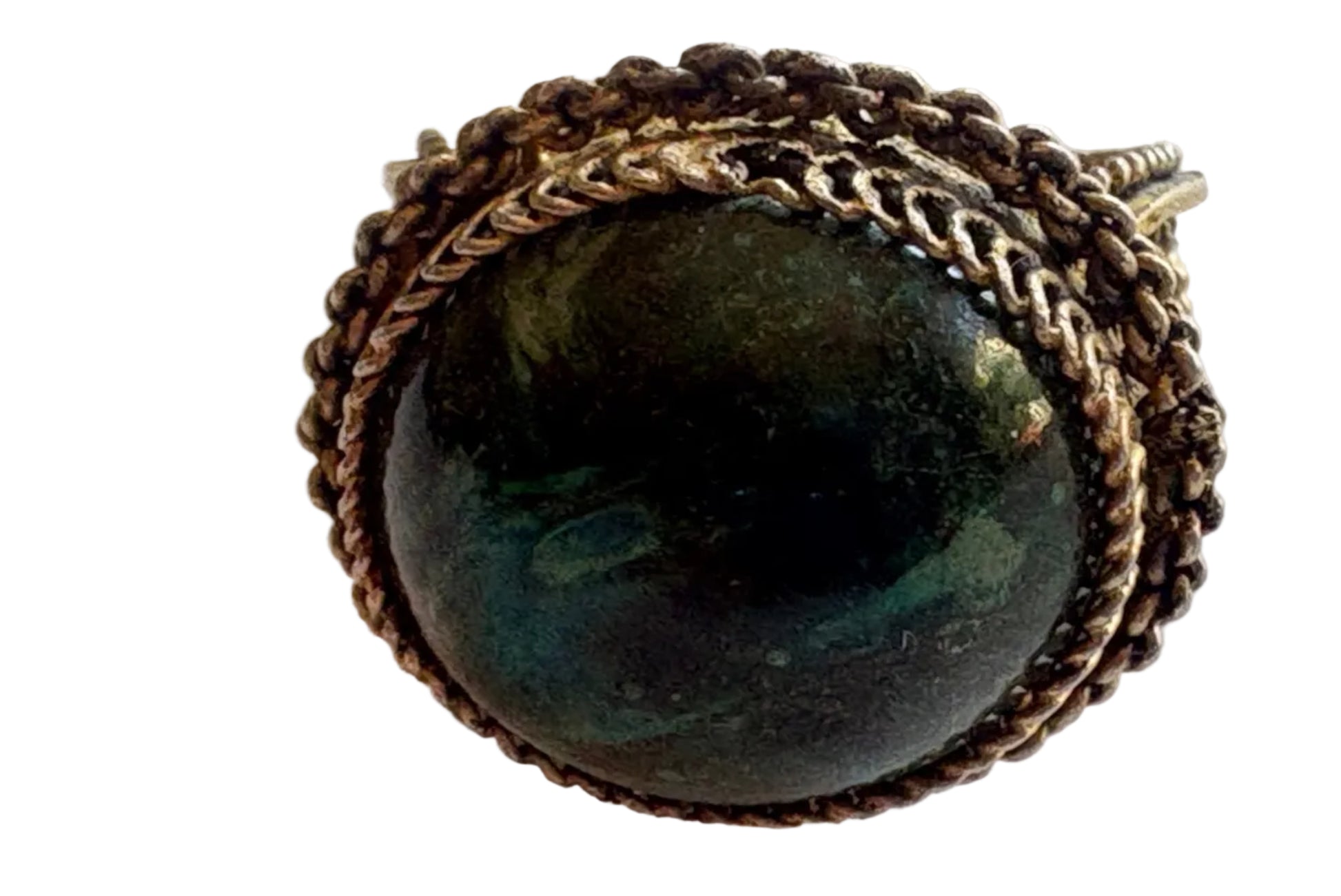 Ring with a dark green gemstone and intricate metalwork on a light background