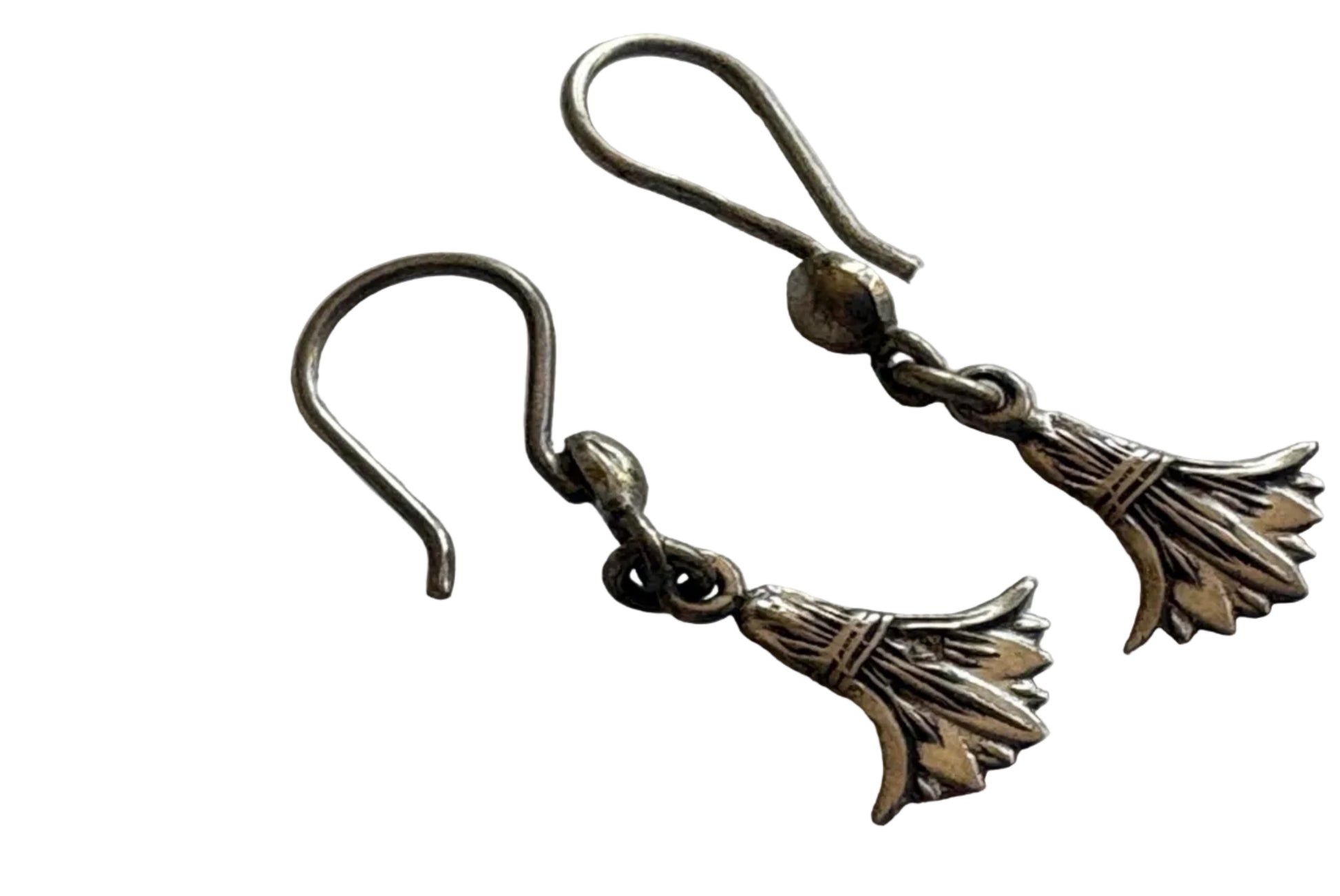 Pair of silver earrings with lotus designs on a white background