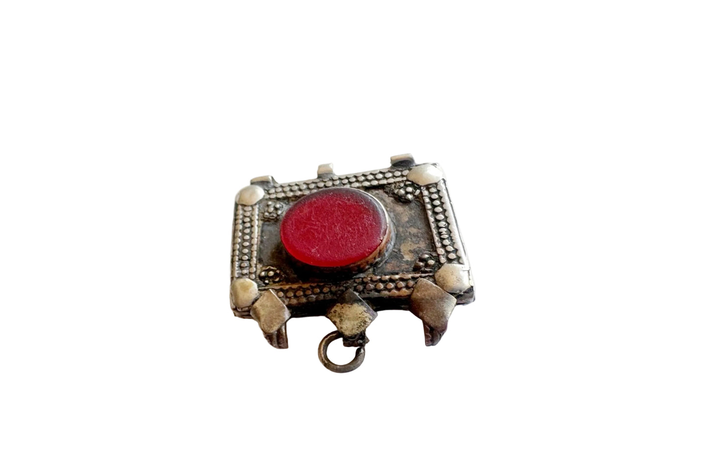 Decorative pendant with a red gemstone on a white background