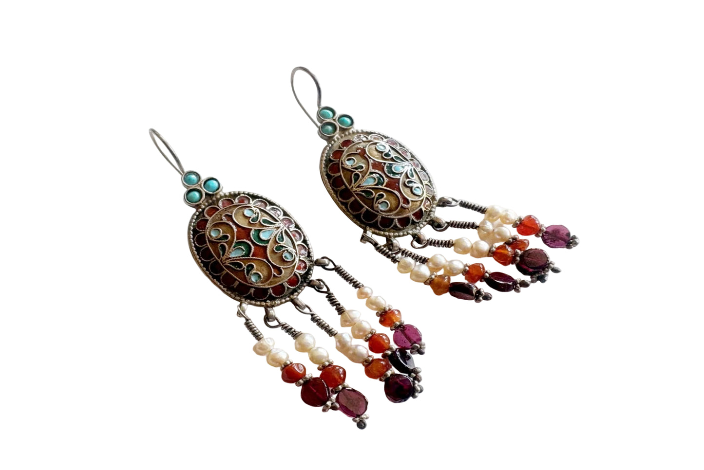 Ornate earrings with beads on a white background