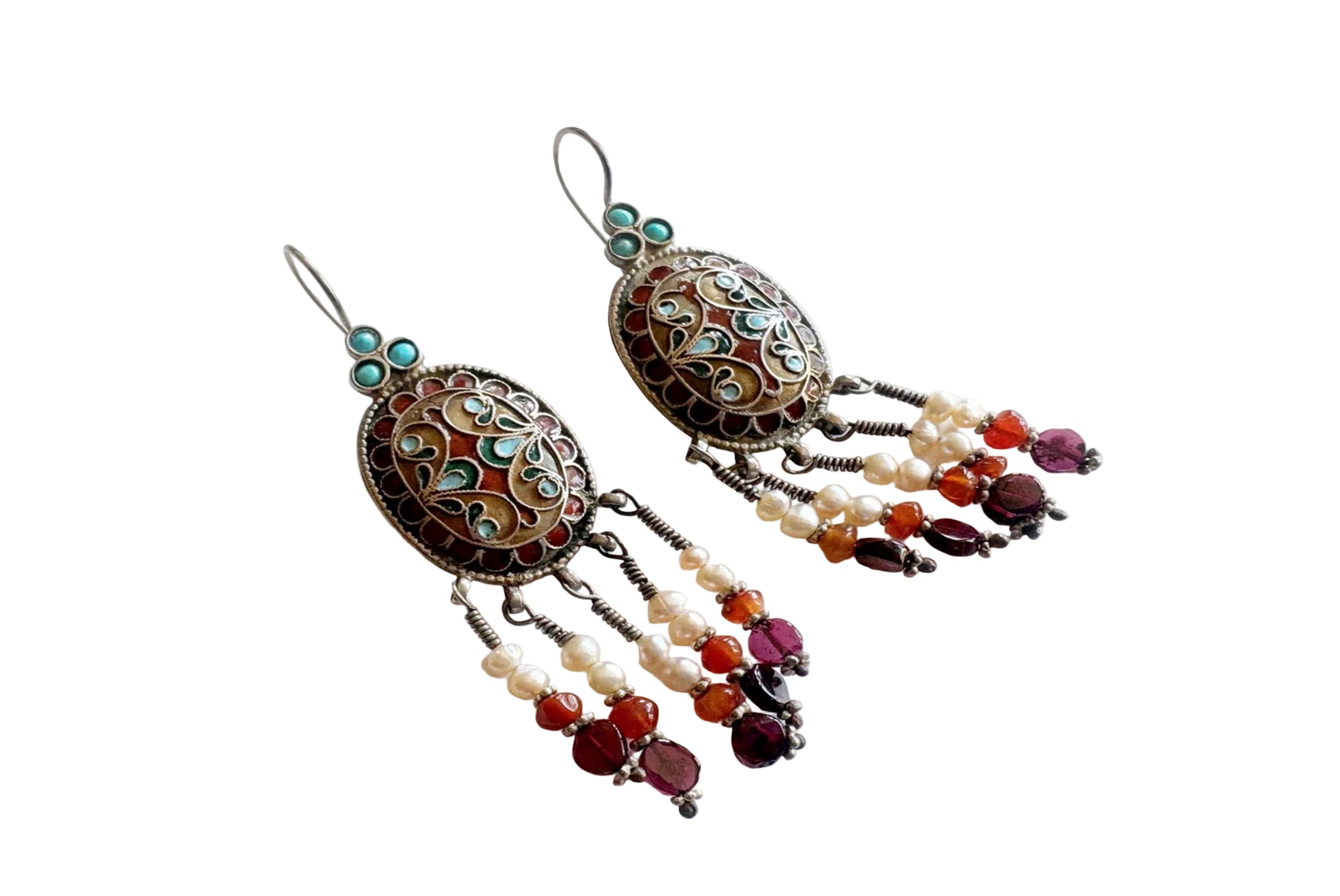Ornate earrings with beads on a white background