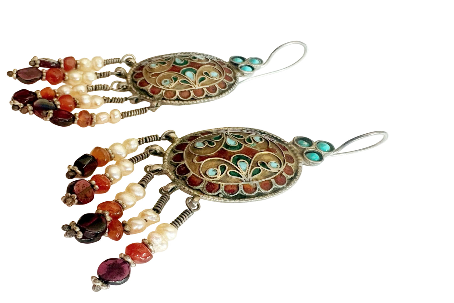 Decorative earrings with gemstones on a white background