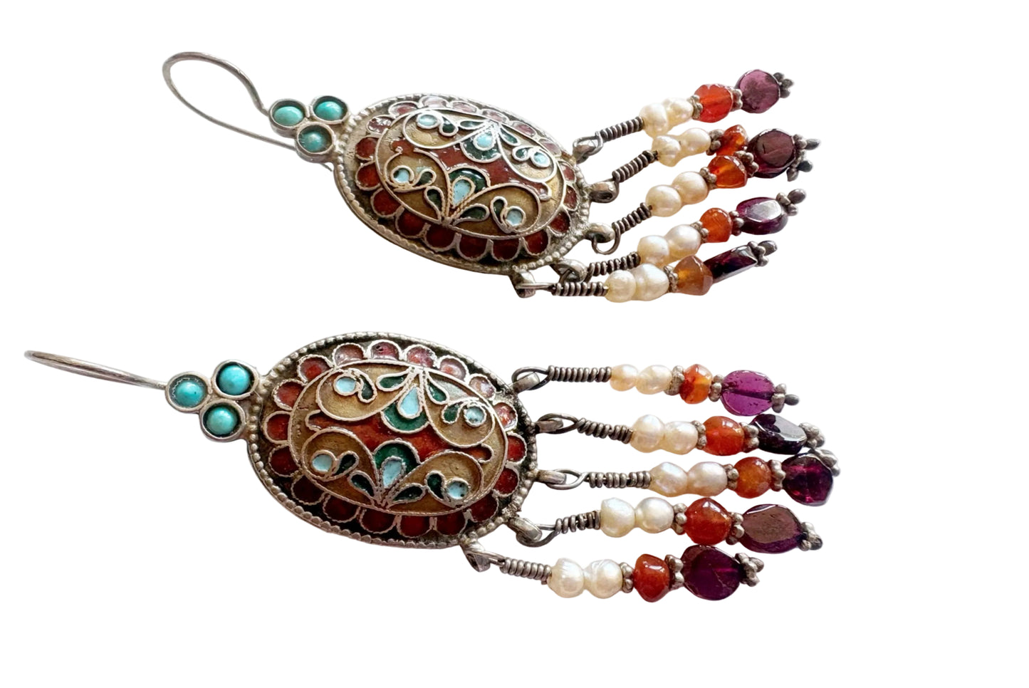 Ornate earrings with bead and pearl details on a white background