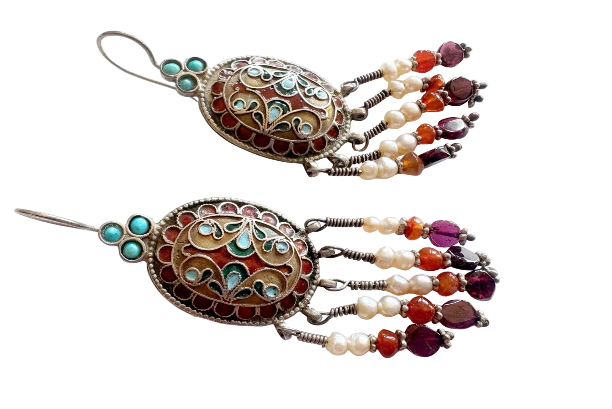 Ornate earrings with bead and pearl details on a white background