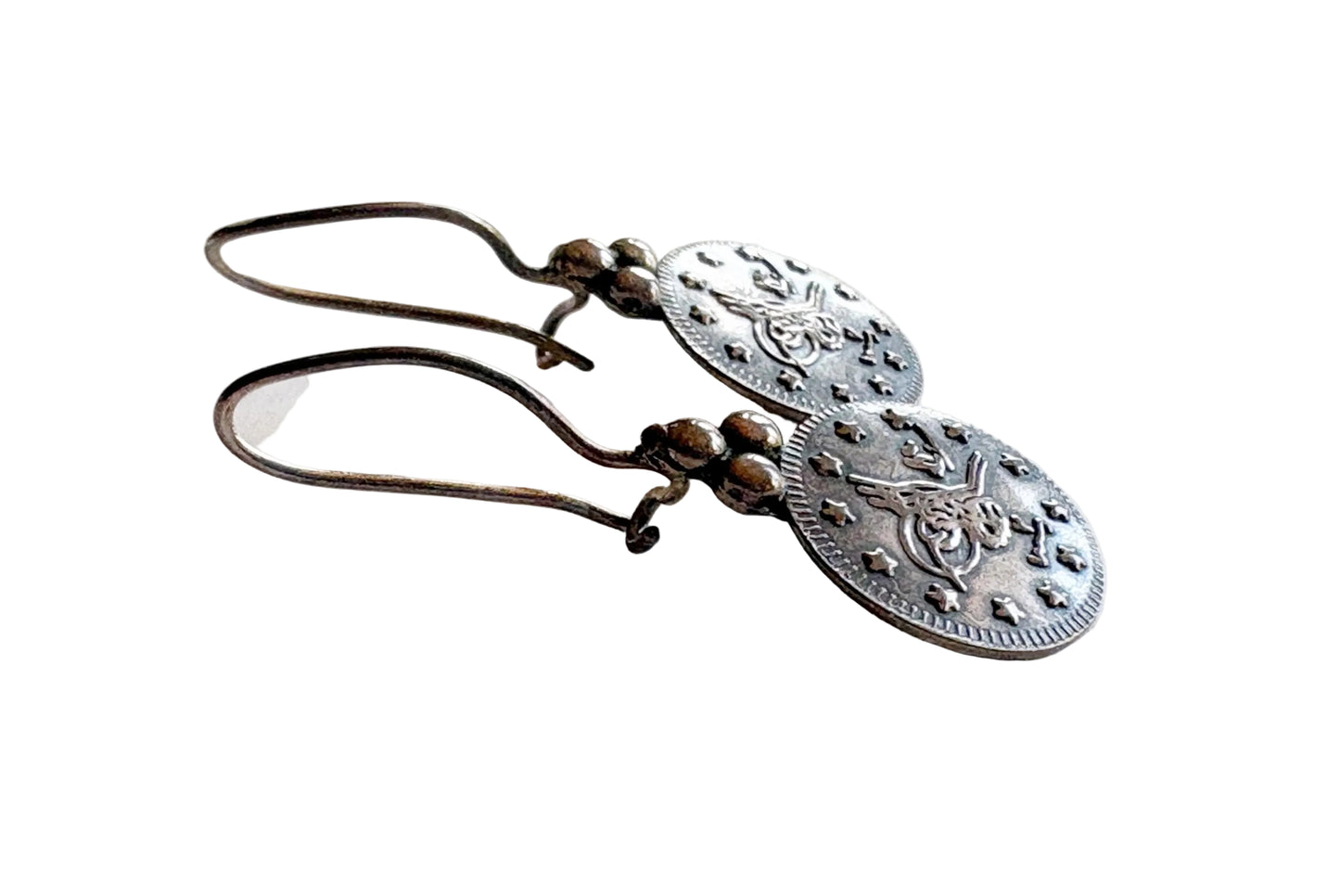 Pair of silver earrings on a light background