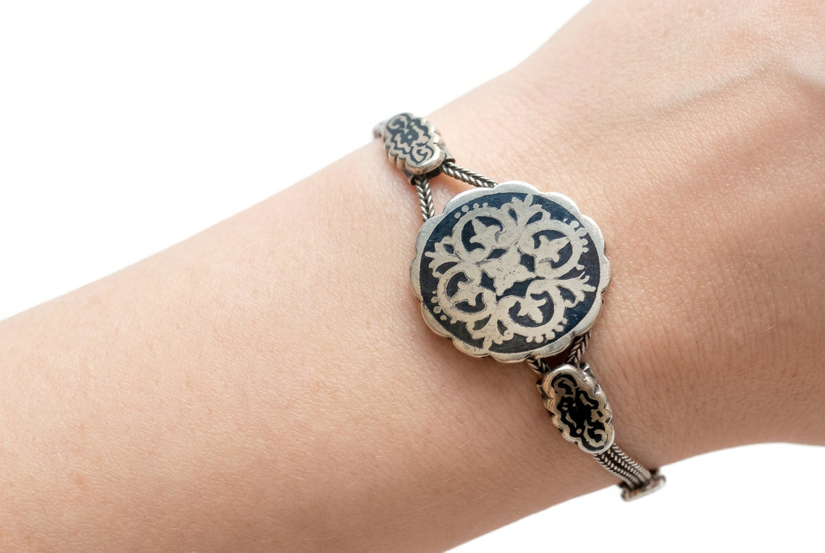 A silver and niello bracelet on an arm