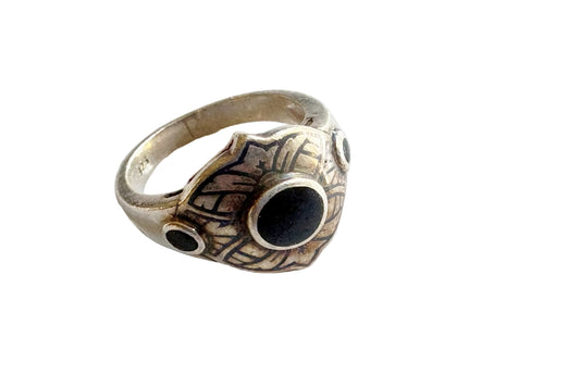 Niello and silver ring on a white background