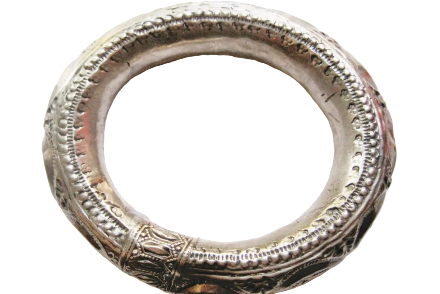 An ornate silver bangle with detailed embossed patterns and a textured finish, shown against a plain white background.