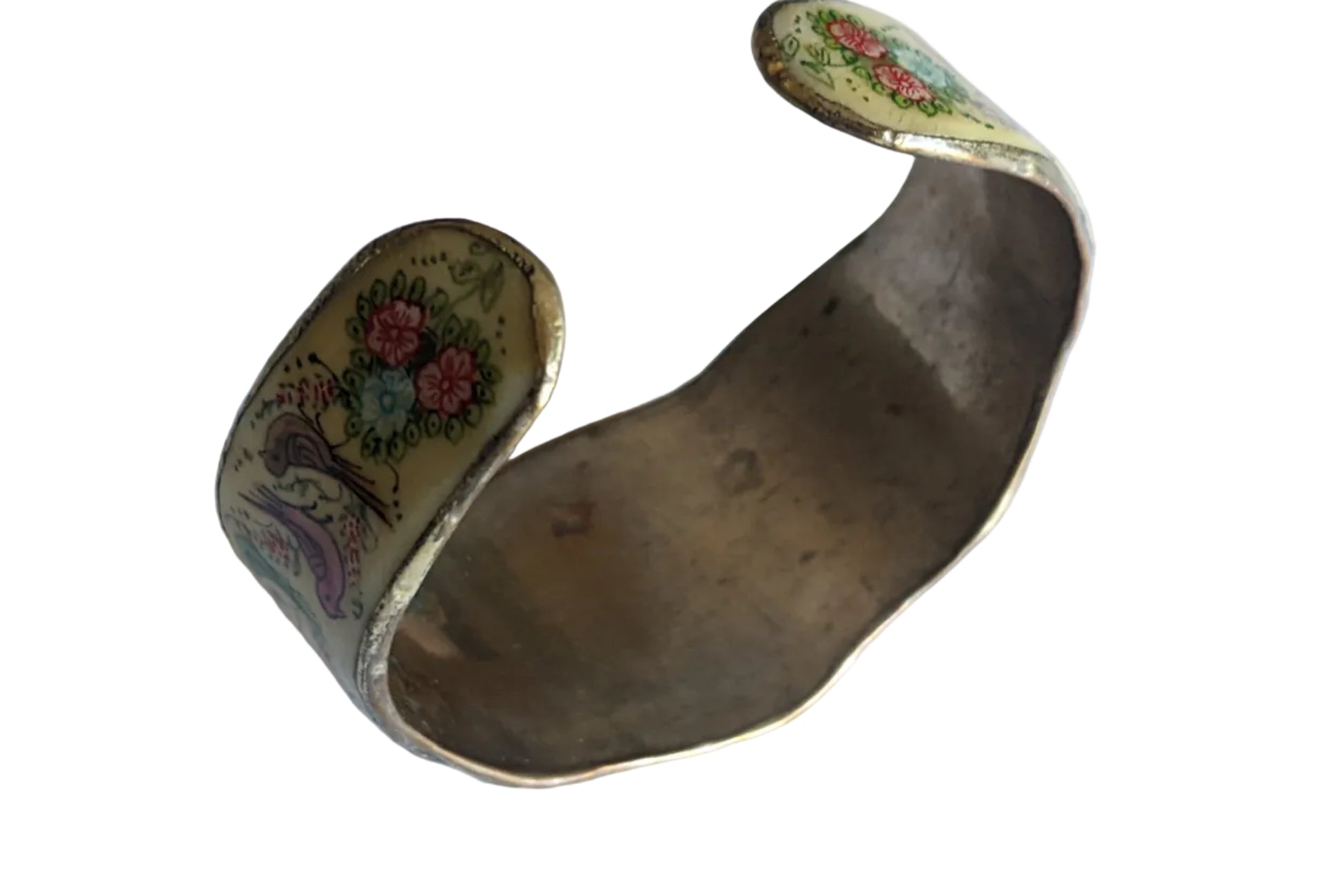 Decorative brass bangle with floral patterns on a white background