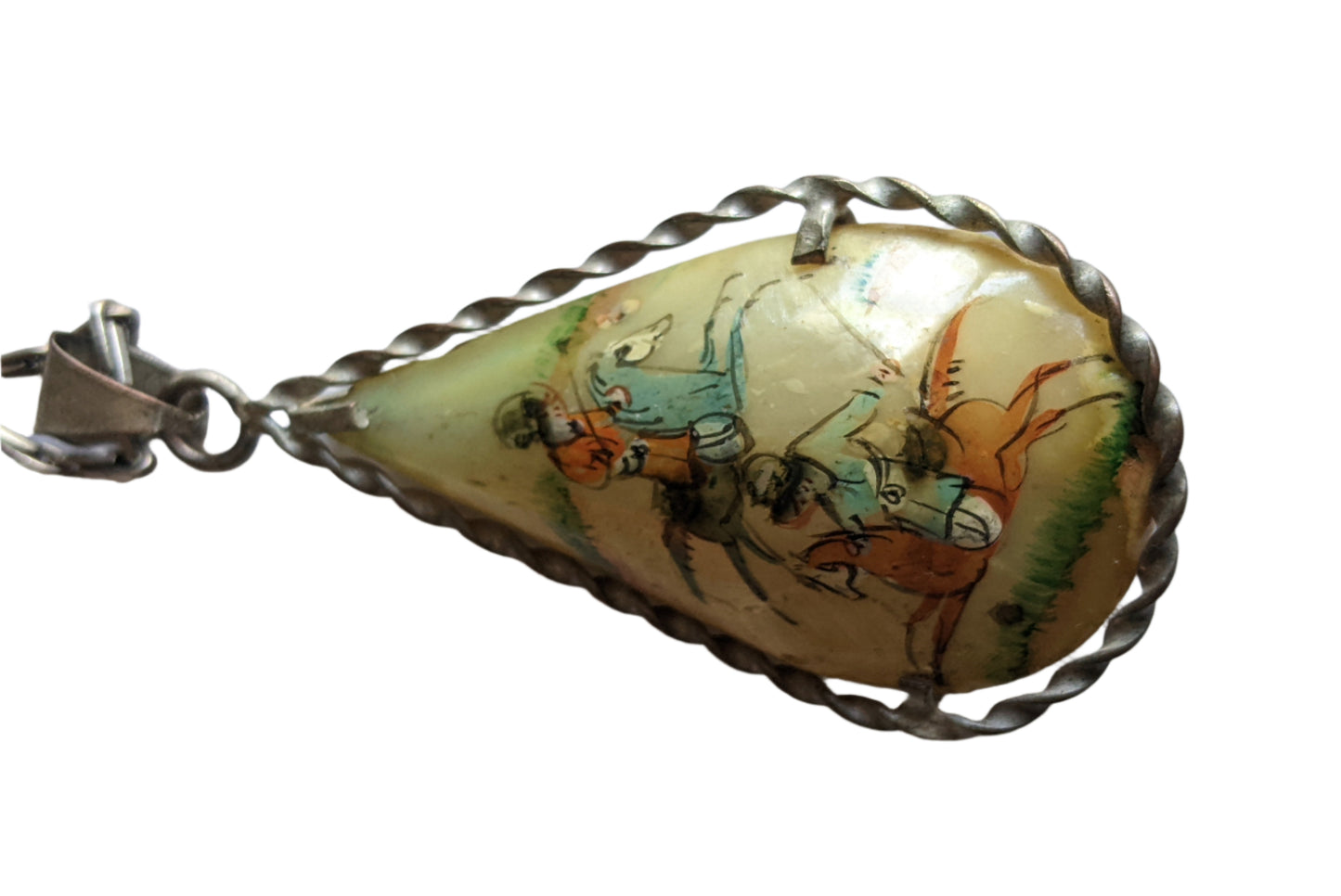Teardrop-shaped mother of pearl pendant with a painted design of two horsemen on a white background